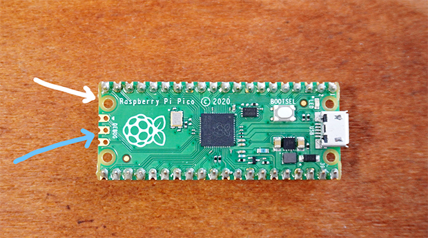 「Raspberry Pi Pico」。青矢印の部分が金フラ。他にも白矢印のところは基材そのままだったりして、よく見るとおしゃれ。